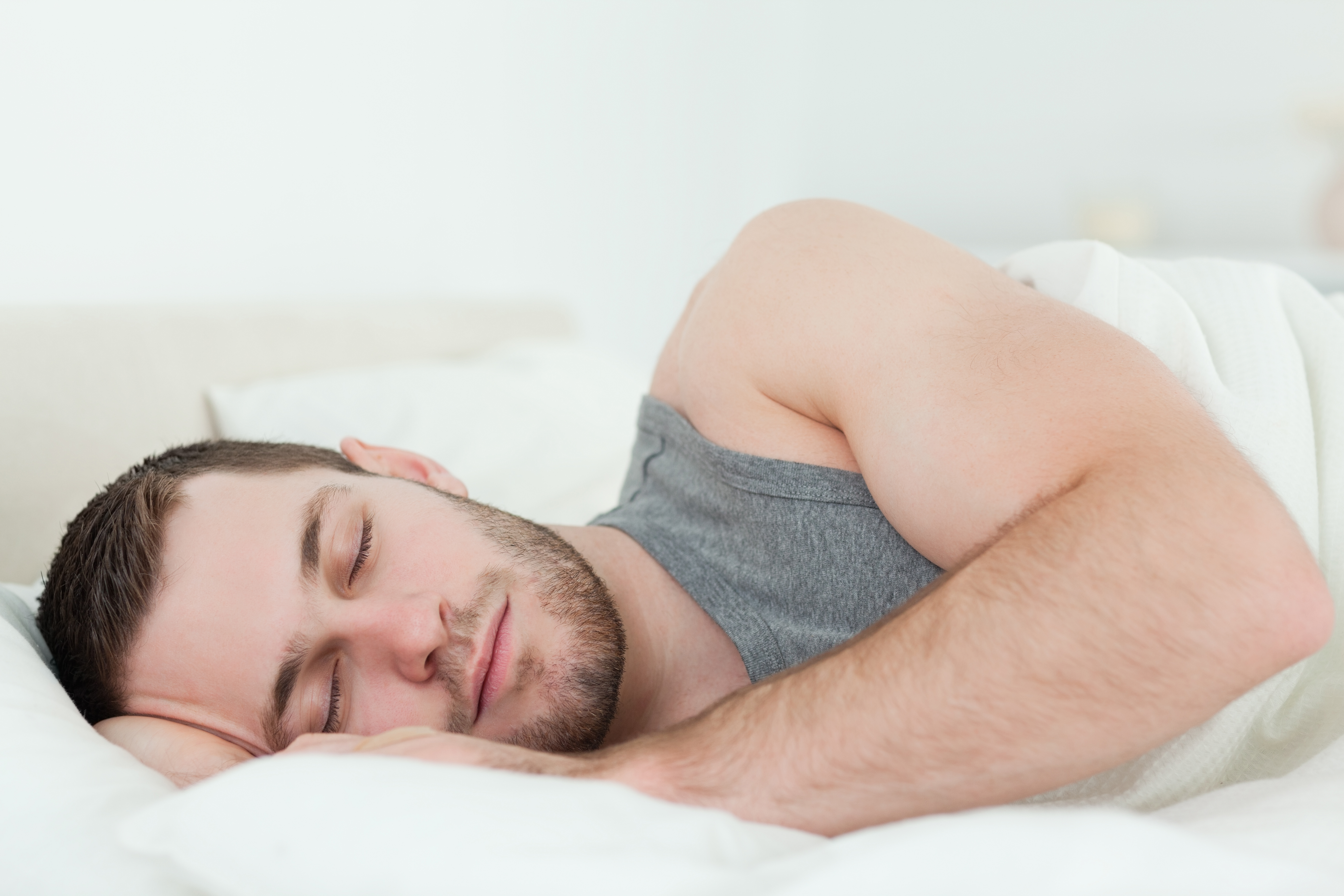 Calm man sleeping in his bedroom
